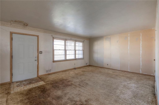 foyer entrance featuring light carpet