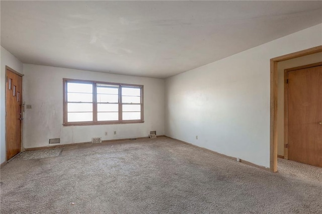 spare room featuring light colored carpet