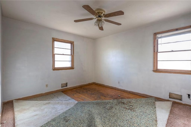 empty room with hardwood / wood-style floors and ceiling fan