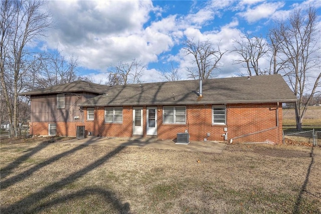 rear view of property with central AC unit and a patio