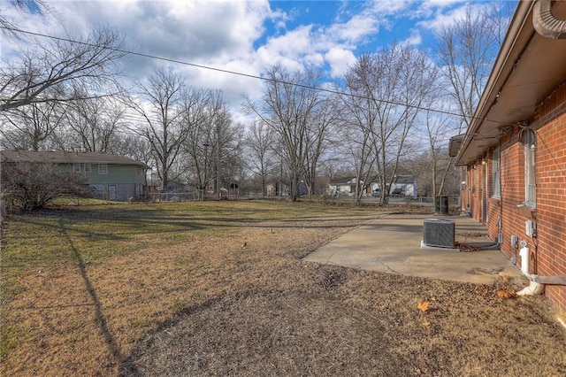 view of yard with central AC and a patio