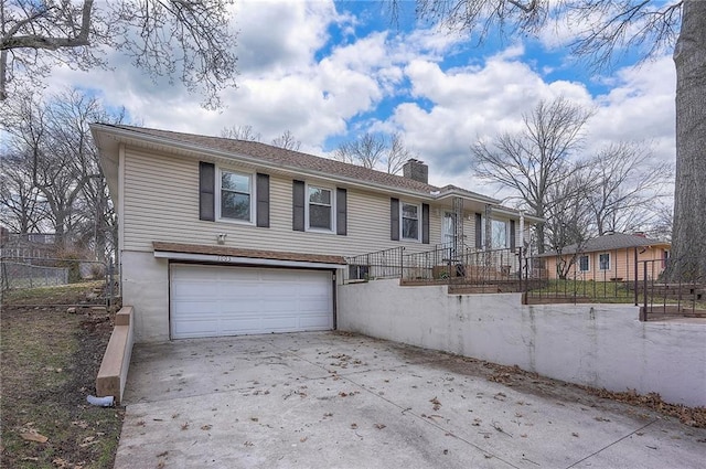 ranch-style house with a garage, driveway, a chimney, and a fenced front yard