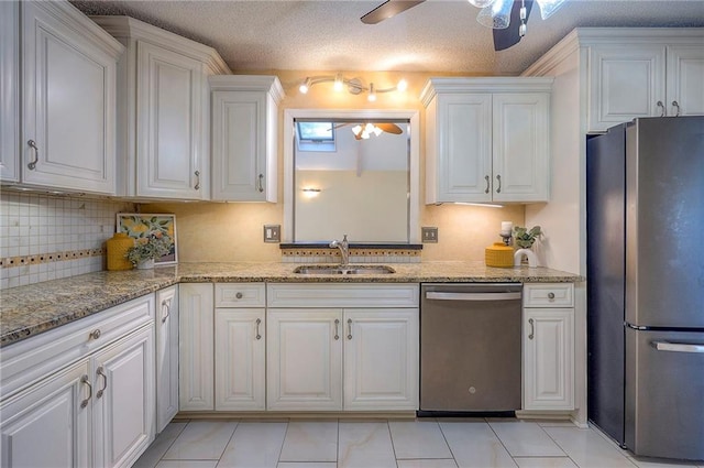 kitchen with white cabinets, a ceiling fan, stainless steel appliances, and a sink