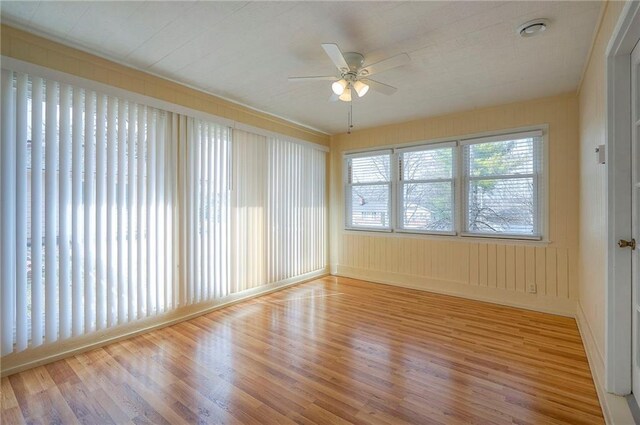 unfurnished sunroom featuring a ceiling fan