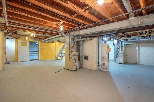 unfinished basement with heating unit, water heater, and stairway