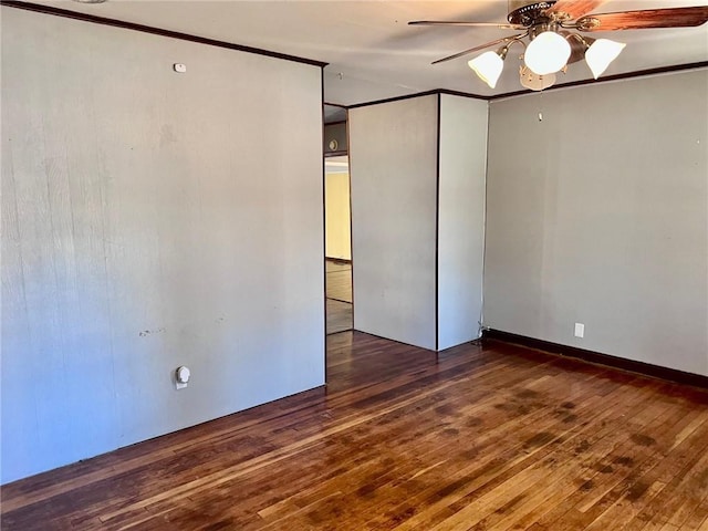 spare room featuring ceiling fan, dark hardwood / wood-style flooring, and ornamental molding