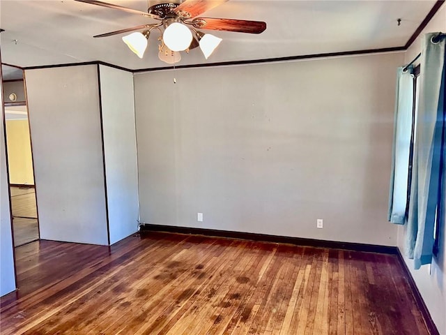 empty room with ceiling fan, wood-type flooring, and ornamental molding