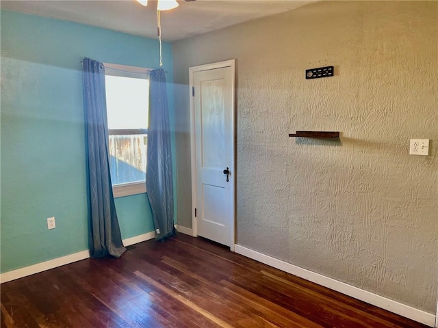 spare room featuring dark hardwood / wood-style flooring