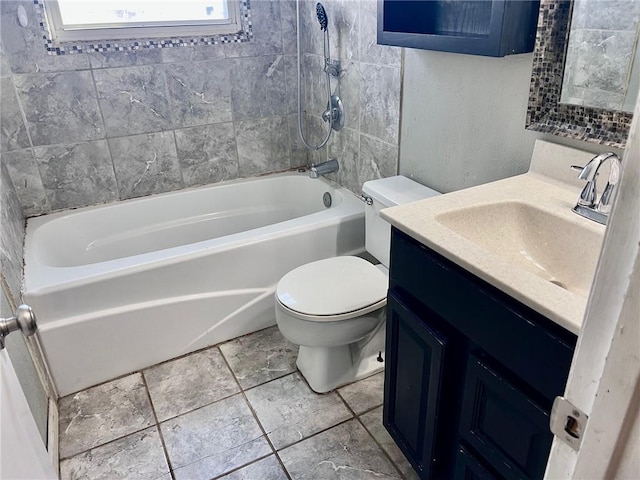 full bathroom featuring vanity, toilet, and tiled shower / bath