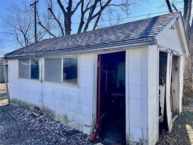 view of side of property featuring an outbuilding