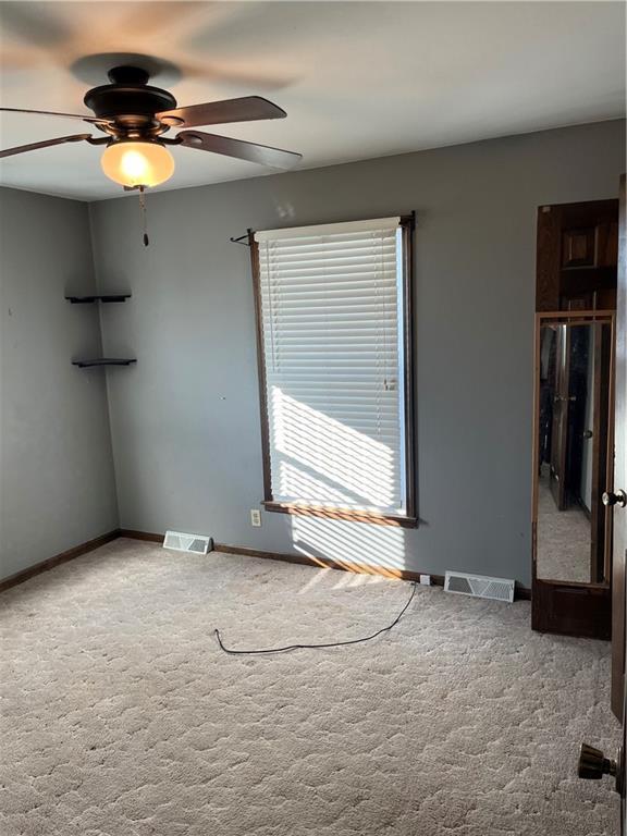 carpeted empty room with ceiling fan