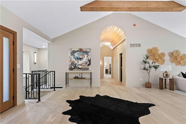 interior space with lofted ceiling with beams and light hardwood / wood-style flooring