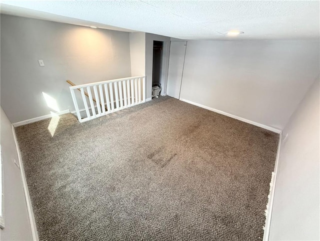 basement featuring carpet floors and a textured ceiling