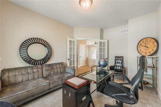 carpeted office space with french doors