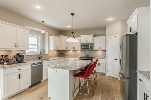 kitchen with a center island, white cabinets, and appliances with stainless steel finishes