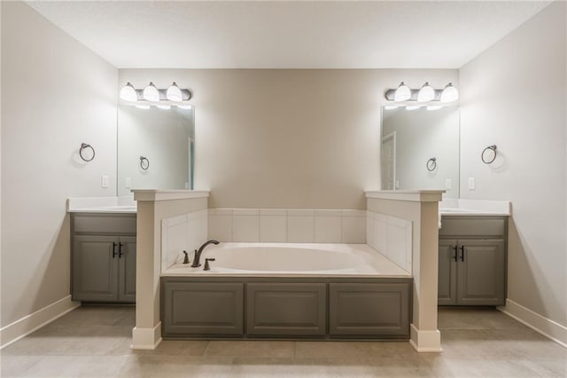 bathroom featuring vanity, tile patterned flooring, and a bathtub