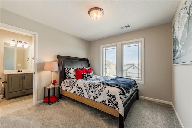 carpeted bedroom featuring connected bathroom