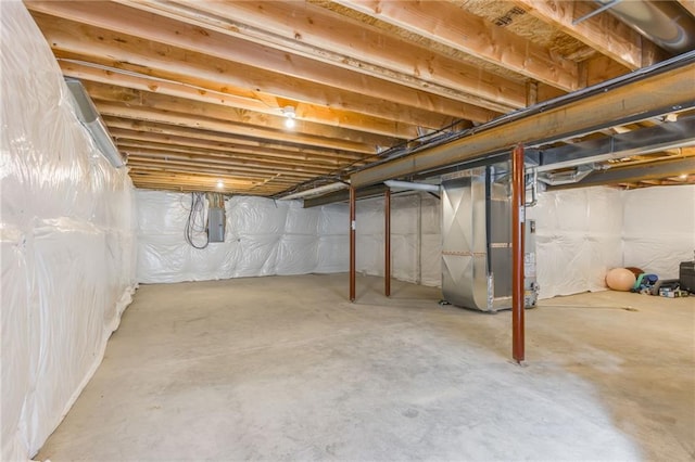 basement with heating unit and electric panel