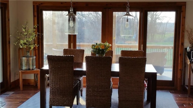 dining space with visible vents and wood finished floors