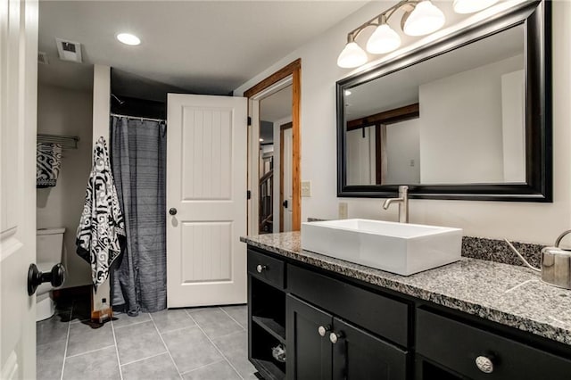 bathroom with tile patterned flooring, toilet, a shower with shower curtain, visible vents, and vanity