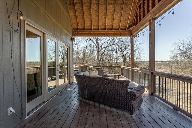 wooden terrace featuring an outdoor living space and french doors