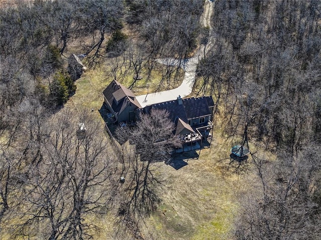 drone / aerial view featuring a wooded view