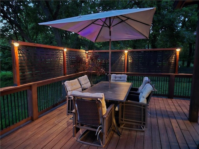 deck featuring a fenced backyard and outdoor dining area