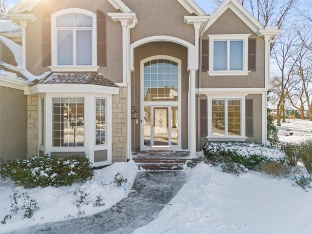 view of snow covered property entrance