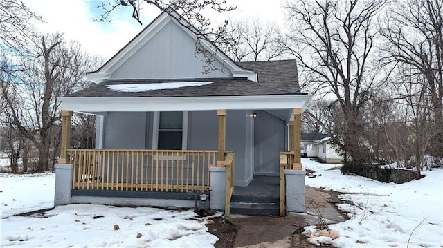 snow covered house with covered porch