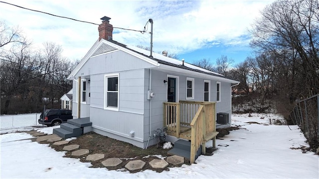 view of snow covered exterior with central AC