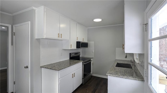 kitchen with light stone countertops, stainless steel appliances, and white cabinets