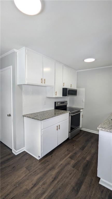 kitchen with appliances with stainless steel finishes, dark hardwood / wood-style floors, light stone countertops, and white cabinets