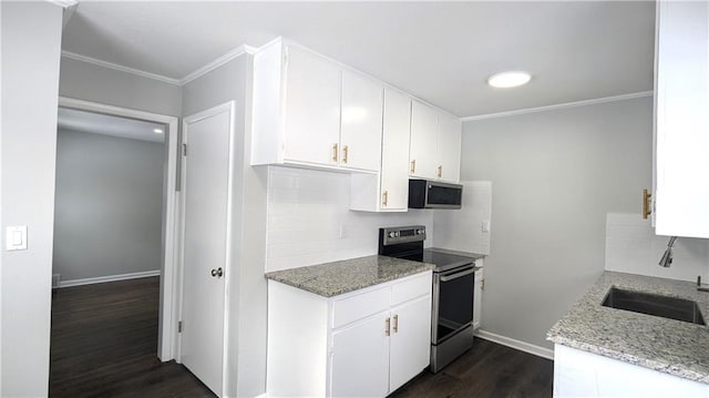 kitchen with sink, light stone countertops, white cabinets, and appliances with stainless steel finishes