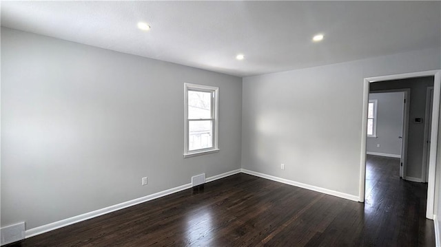 spare room featuring dark wood-type flooring