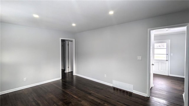 unfurnished room with dark hardwood / wood-style flooring