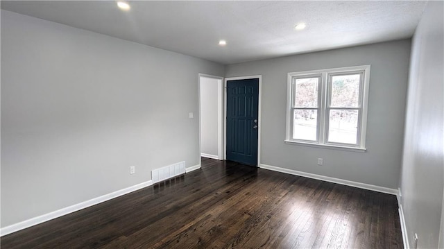 empty room with dark wood-type flooring