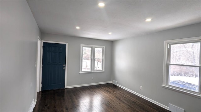 foyer with dark hardwood / wood-style floors