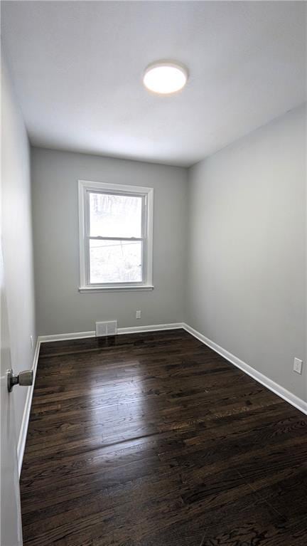 empty room featuring dark wood-type flooring