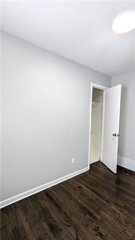 spare room with dark hardwood / wood-style flooring