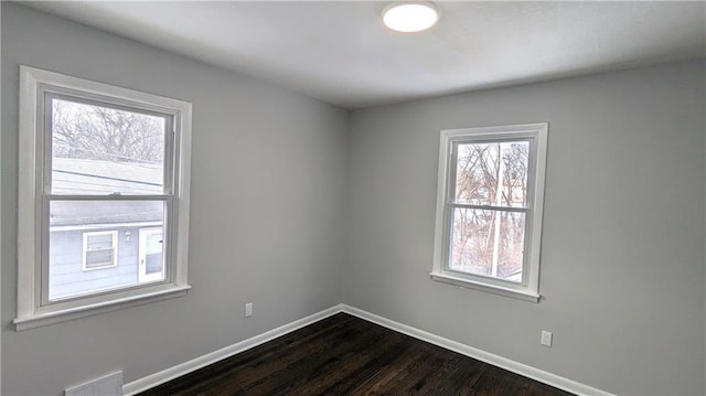 spare room with dark hardwood / wood-style floors