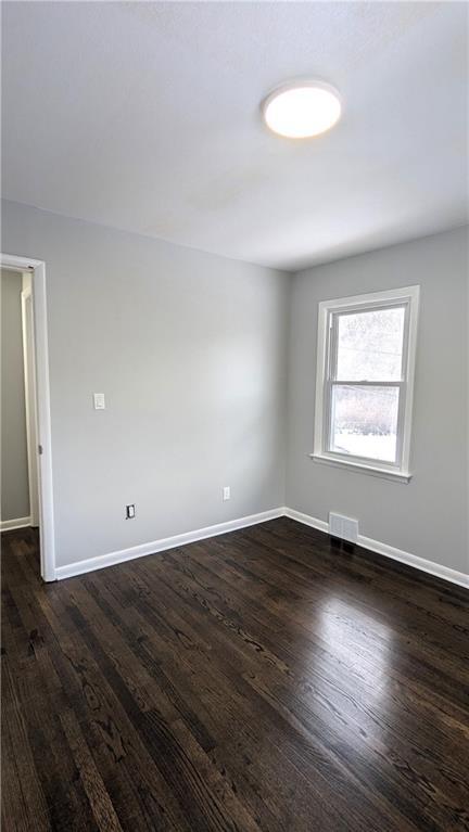 unfurnished room featuring dark hardwood / wood-style floors