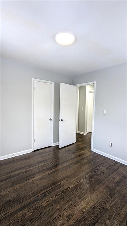 empty room with dark hardwood / wood-style floors