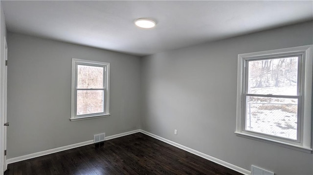 unfurnished room with dark wood-type flooring