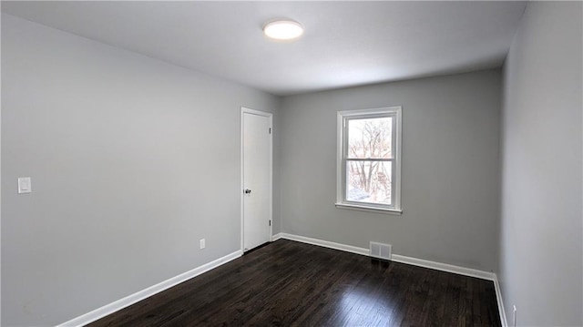 empty room featuring dark hardwood / wood-style floors