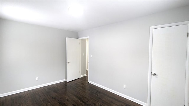 unfurnished room featuring dark hardwood / wood-style floors