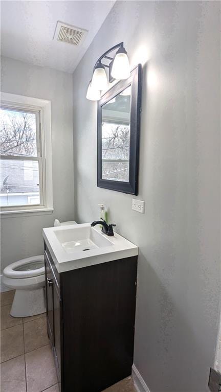 bathroom featuring tile patterned floors, vanity, and toilet