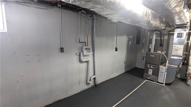 basement featuring electric panel and heating unit