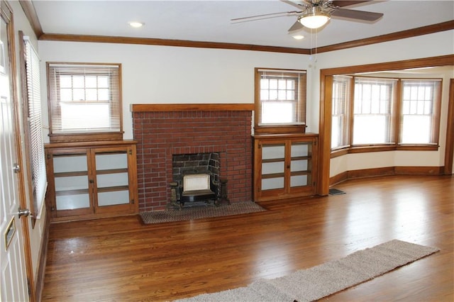 unfurnished living room featuring hardwood / wood-style flooring, ceiling fan, and crown molding