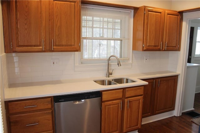 kitchen with dishwasher, dark hardwood / wood-style flooring, backsplash, and sink