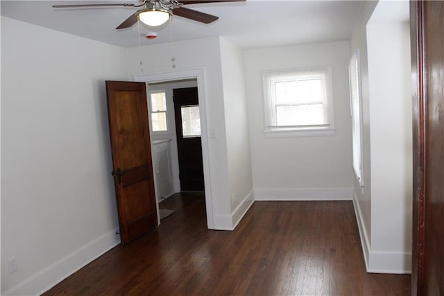 interior space with ceiling fan and dark hardwood / wood-style flooring